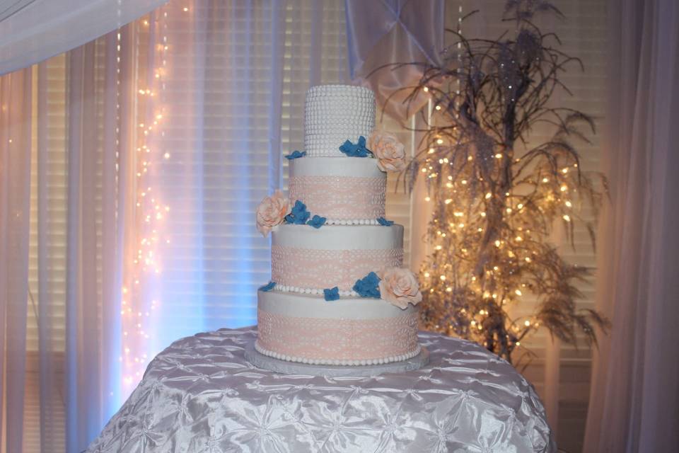 Simple and clean 4 tier cake with flower accents!