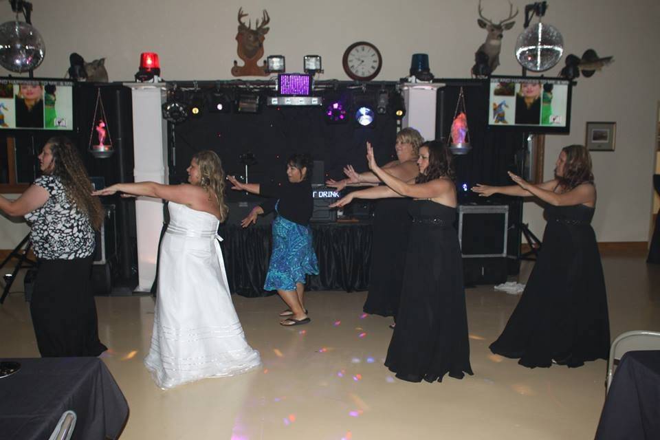 The bride and her bridesmaids line dancing.