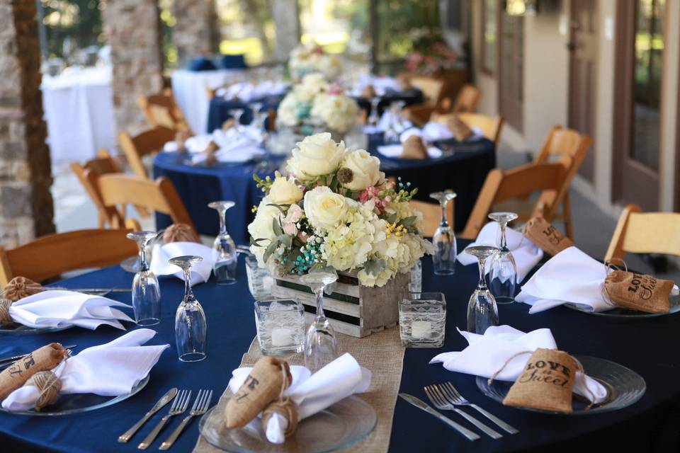 Navy reception tables and floral centerpieces