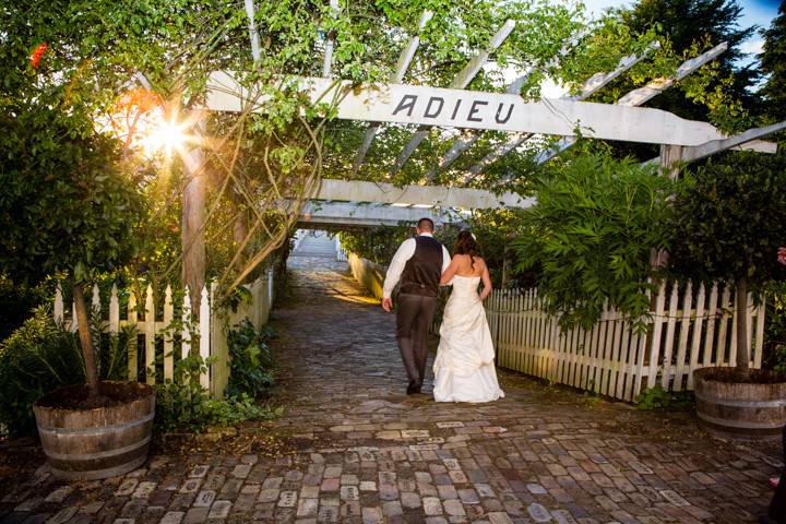 Bride & Groom walking under the wisteria towards the docks at Roche Harbor