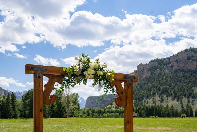 Wooden arch with floral on top