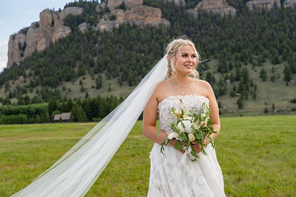 Bride with bouquet, mountains