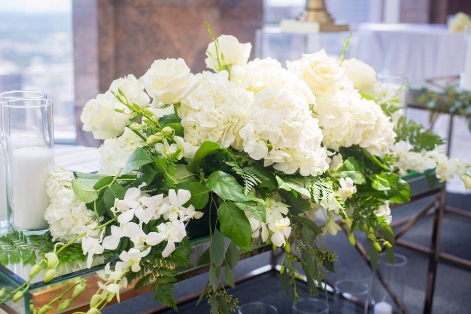 White Hydrangea and White Roses Sweetheart Table Floral Arrangement
