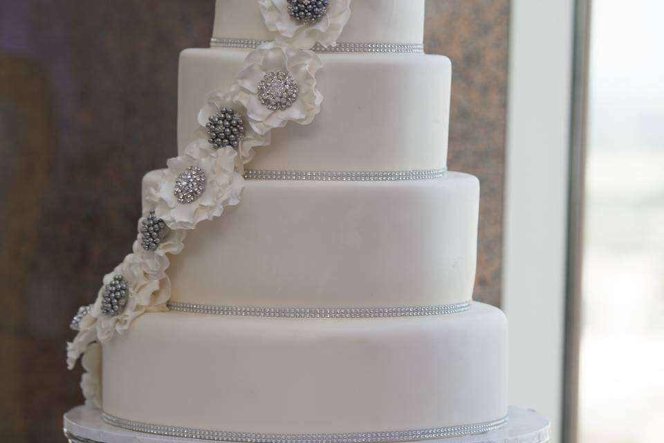 White Five-Tiered Wedding Cake with Crystal Brooches