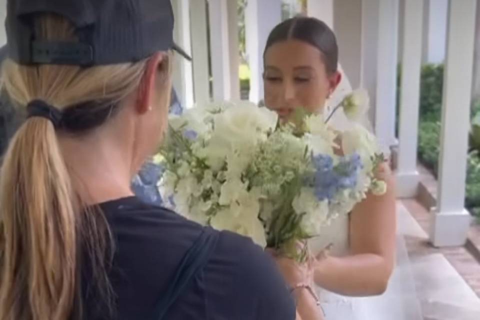 Handing the bridal bouquet