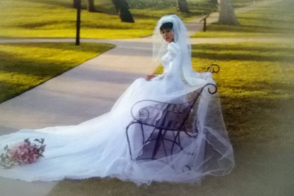 Custom design and tailor wedding gown and veil.