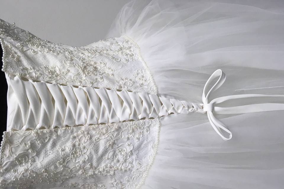 Add the lace up corsets to the wedding gown.
