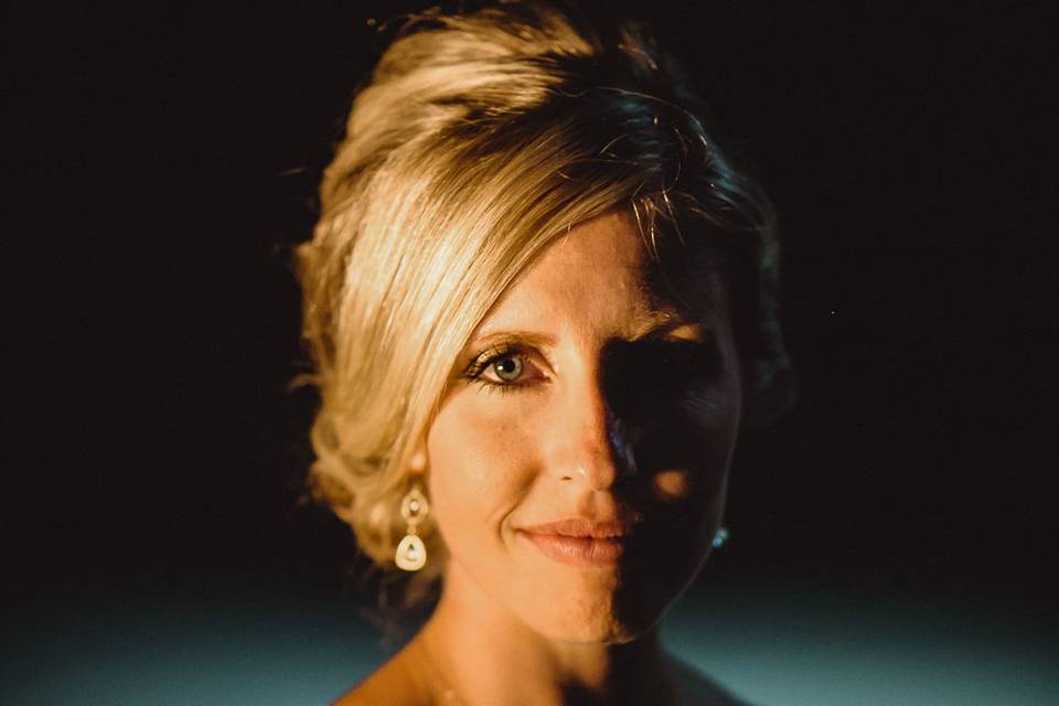 A bride stands beside a fire during her wedding reception art Crystal Mountain Resort.