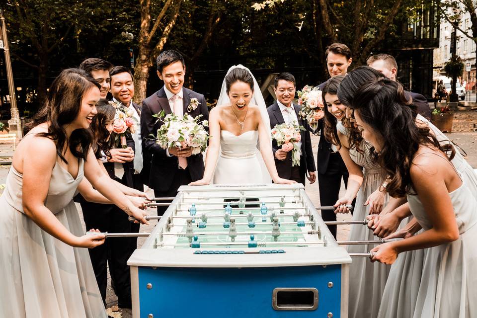 A wedding party plays games before their Sodo Park wedding.