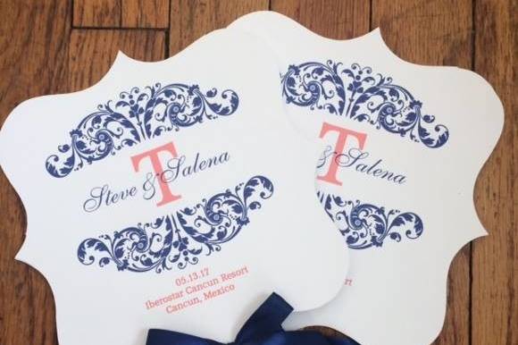 Coral and navy bracket shaped wedding program fan embellished with navy bow