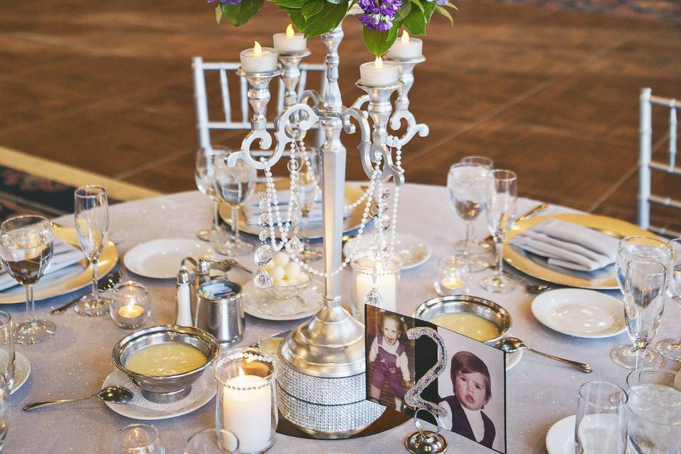 Rich tones of purple, red and lavender with dark greens, pop on this silver candelabra.