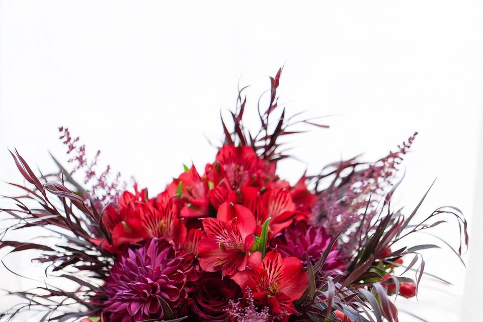 Hollywood glam in shades of red for these bridesmaids bouquets.  Roses, agonis, alstromeria, dahlias and hypericum berries and red astilbe fill out this look.