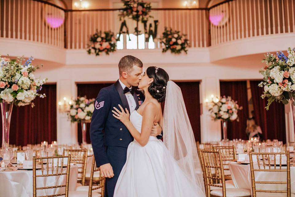 The wedded couple kiss