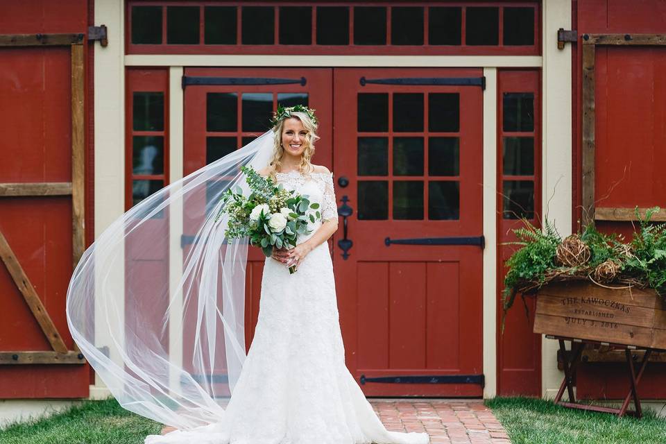 Bride by the barn entrance