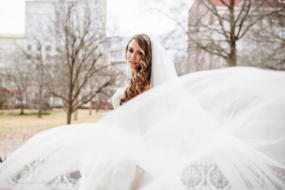 Bride holding up her gown