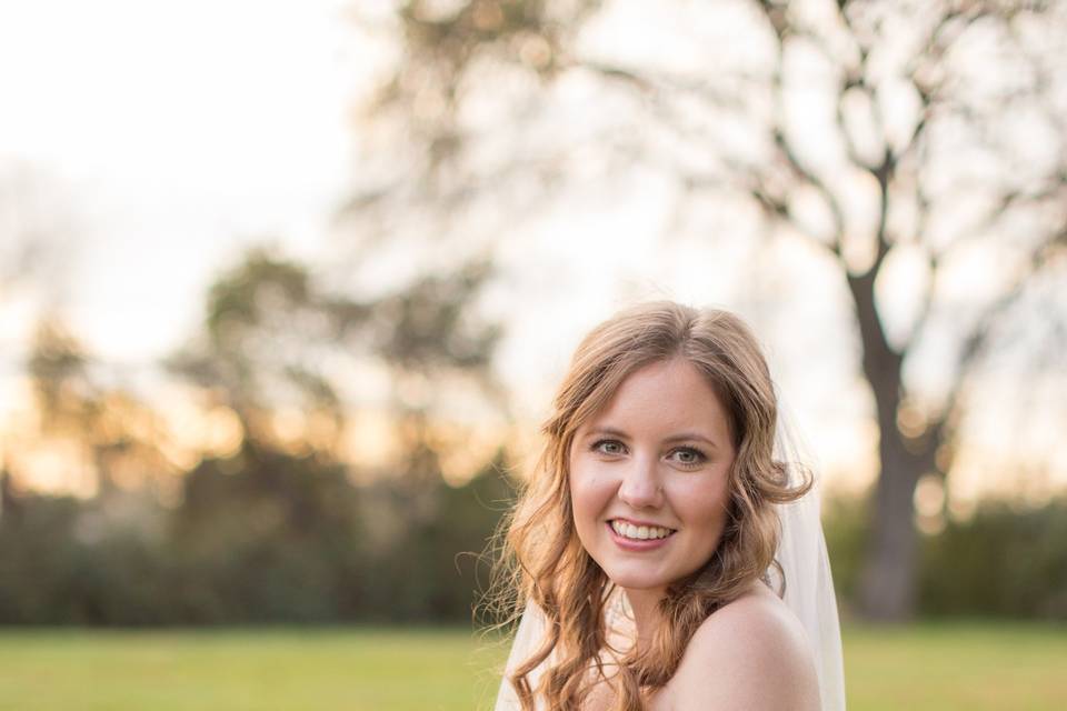 Smiling wedding celebrant with bouquet - Ares Photography