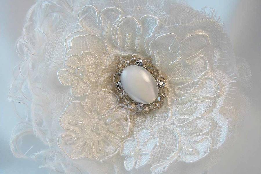 vintage inspired fascinator with Alencon lace, silk organza and an ivory mother of pearl and Swarovski crystal center