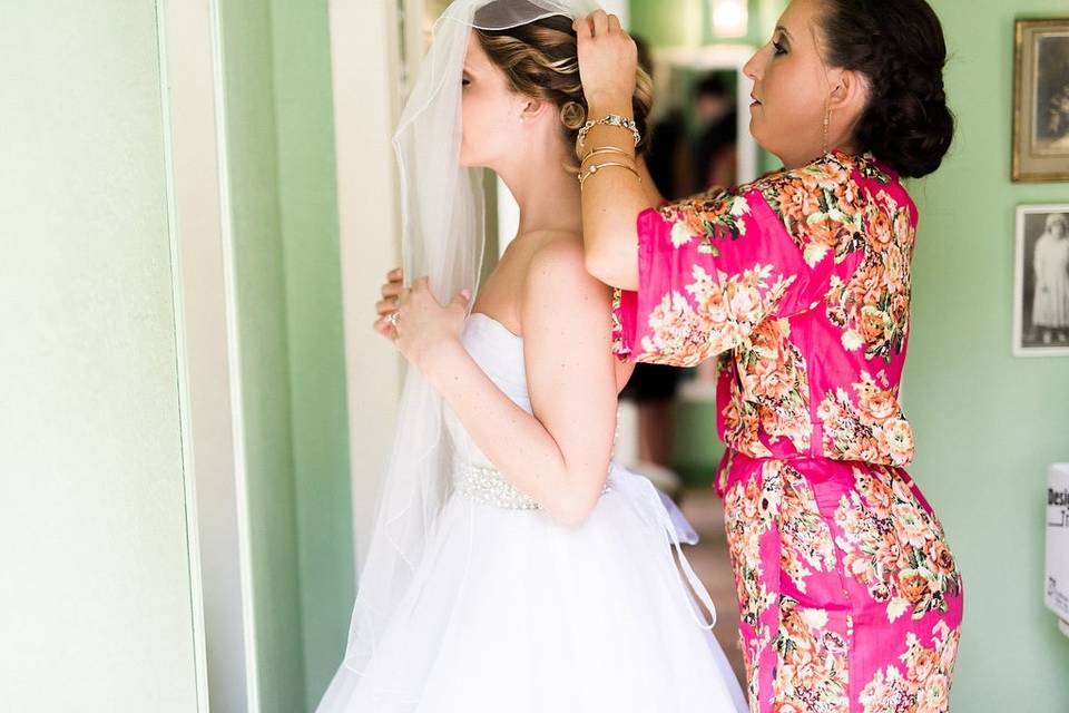 Victoria's Maid of Honor putting on her veil.