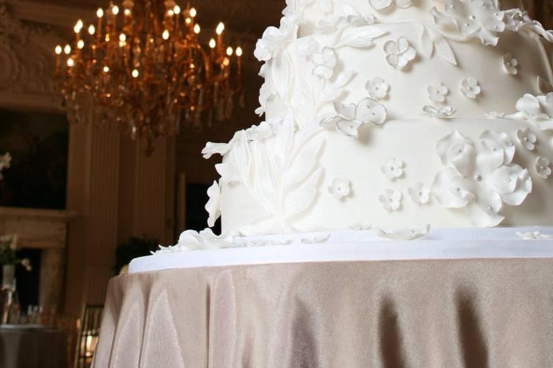 5-round tiers embellished with gum paste white sugar flowers and appliques inspired by bride's gown.