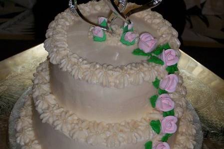Small Double Tiers Wedding cake with edible pink roses cascading down the side.