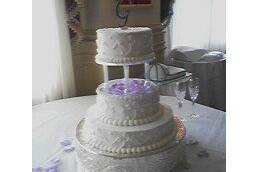 White, three tiers scroll wedding cake
