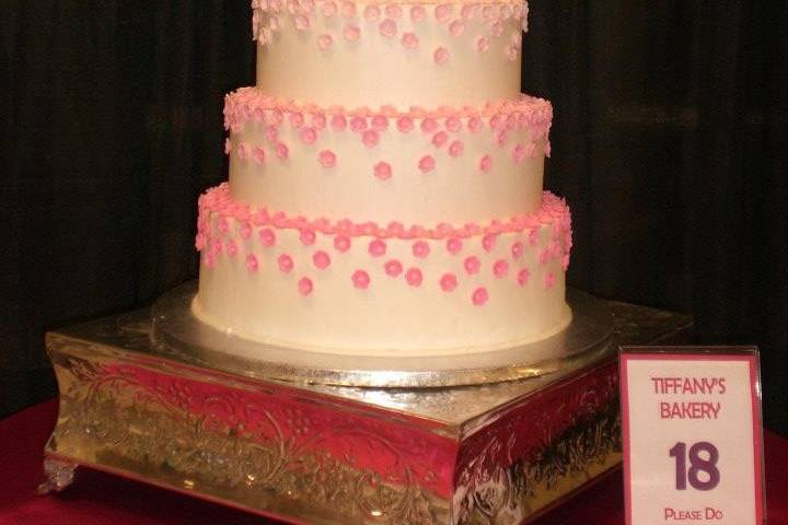 White wedding cake with a touch of pink