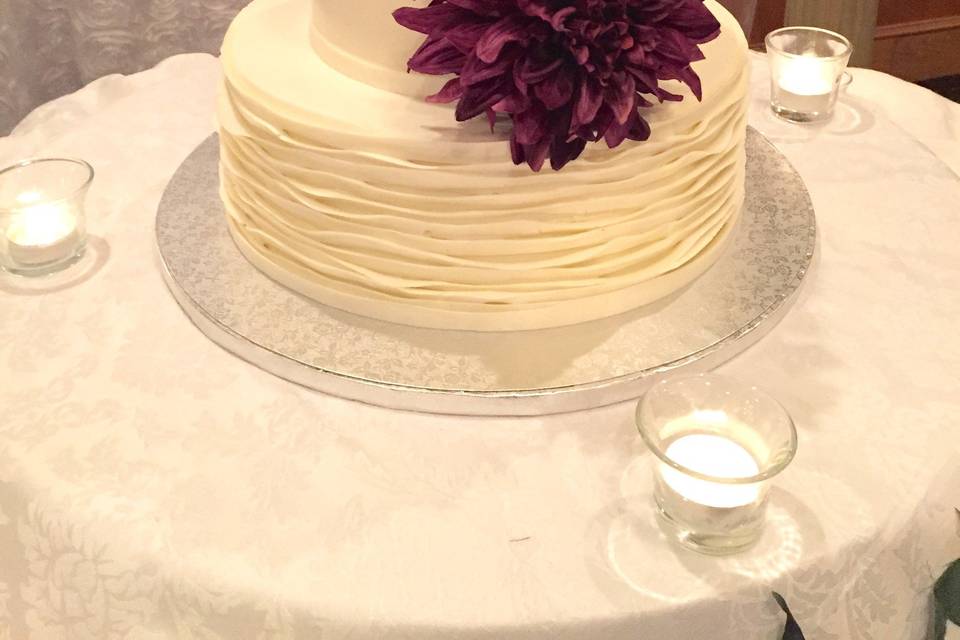 Wedding cake with deep purple flowers
