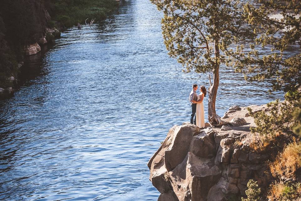 Happy couple embracing on cliff