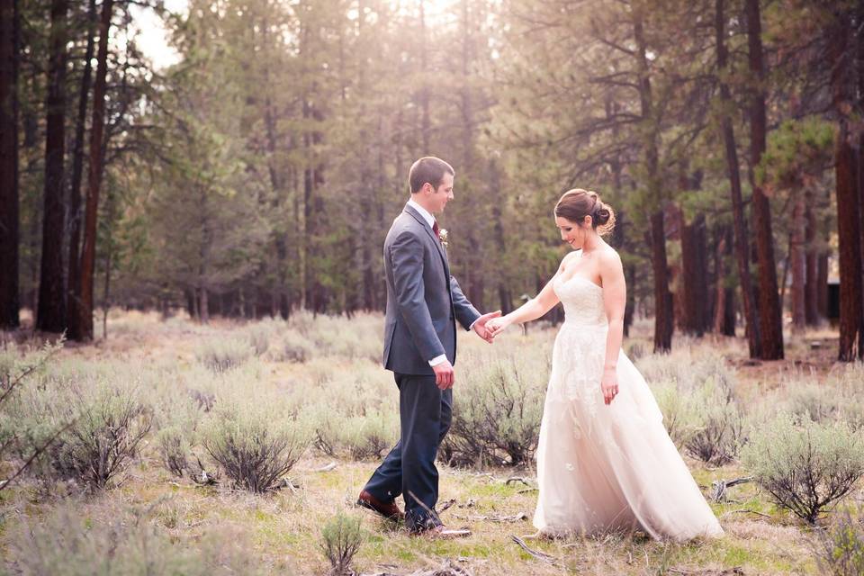 Happy couple holding hands in forest