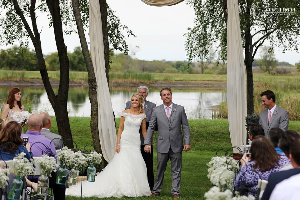 Open-air ceremony near pond