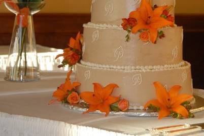 This cake was iced and decorated in buttercream icing.  Rhinestone studded ribbon adorn two of the tiers.