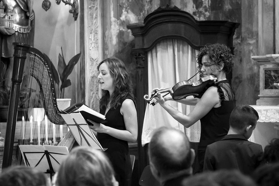 Harpist, soprano and violinist performing during a church ceremony, Santa Margherita