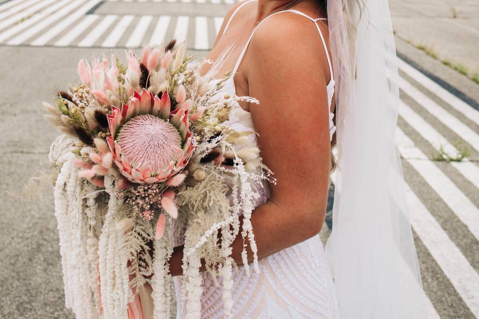 Bride smiling with bouquet