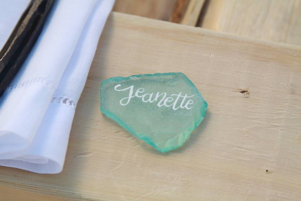 The bride elected to use pieces of sea glass for her guests' place cards. Each piece was lovingly calligraphed with the guest's first name.