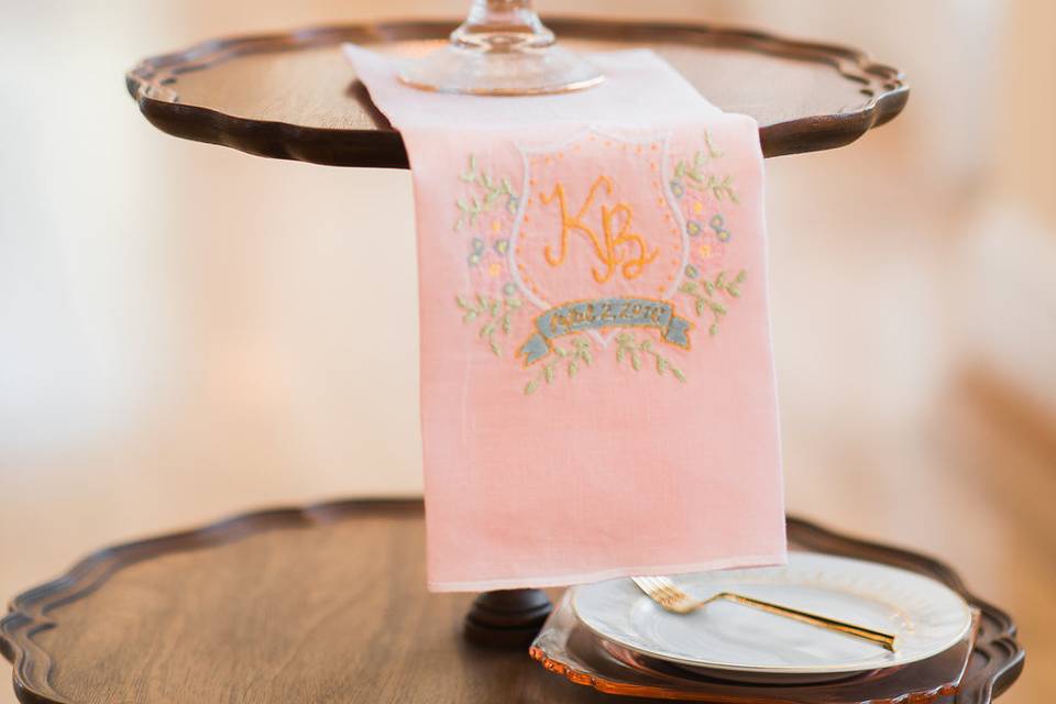 The custom watercolor monogram from the invitation suite was digitized and embroidered onto napkins created by Mimmi and Bee.