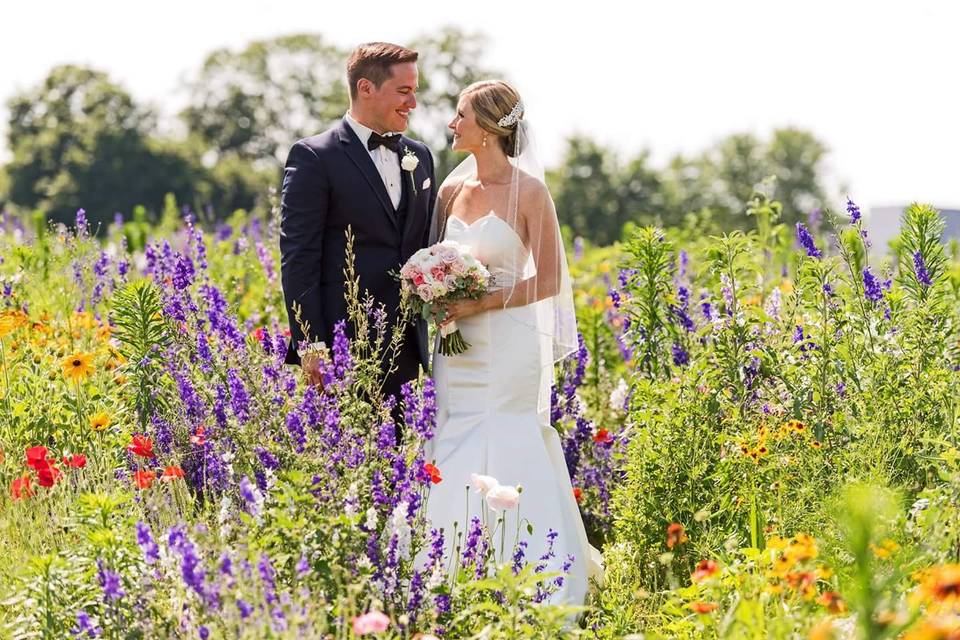 Newlyweds by the field of flowers
