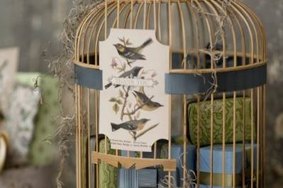 A whimsical birdcage, enclosed with favors wrapped in chic Japanese papers.