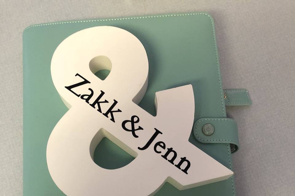 & sign personalized with a custom wedding planner and address book.