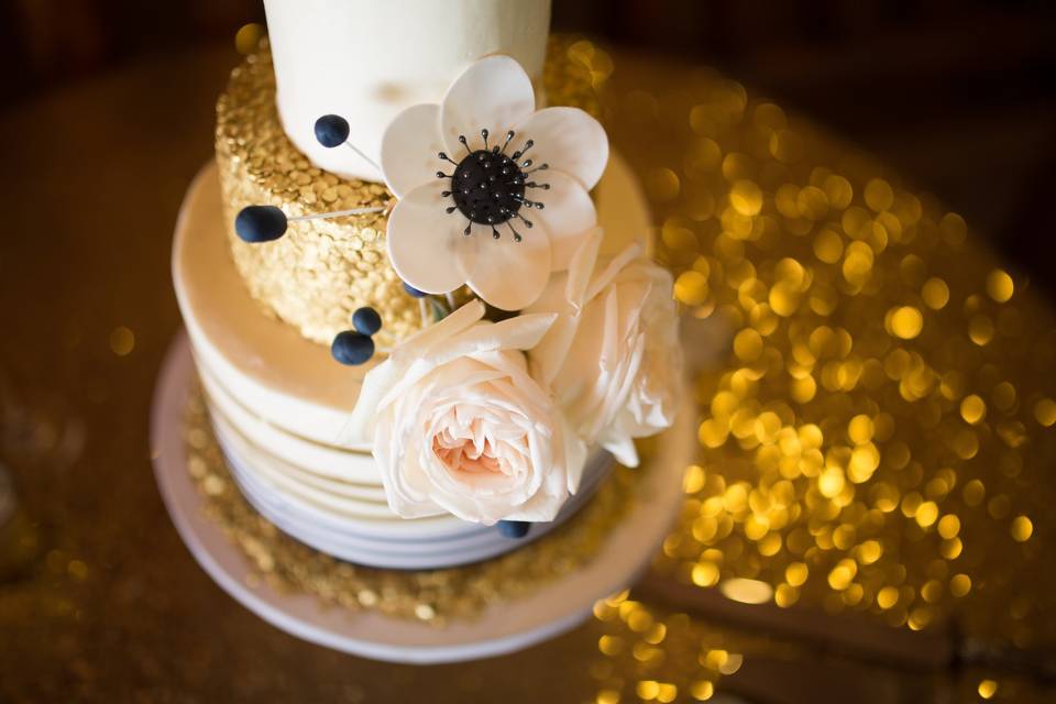 Gold confetti cake with ribbon