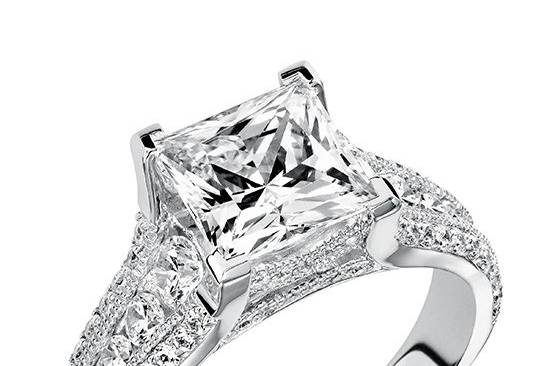 ArtCarved 31-V504HCW <br> HARPER, Estate diamond engagement ring features channel set graduated round diamonds with milgrain detail and prong set diamonds on the shank Milgrain detail is also feature under the center stone
