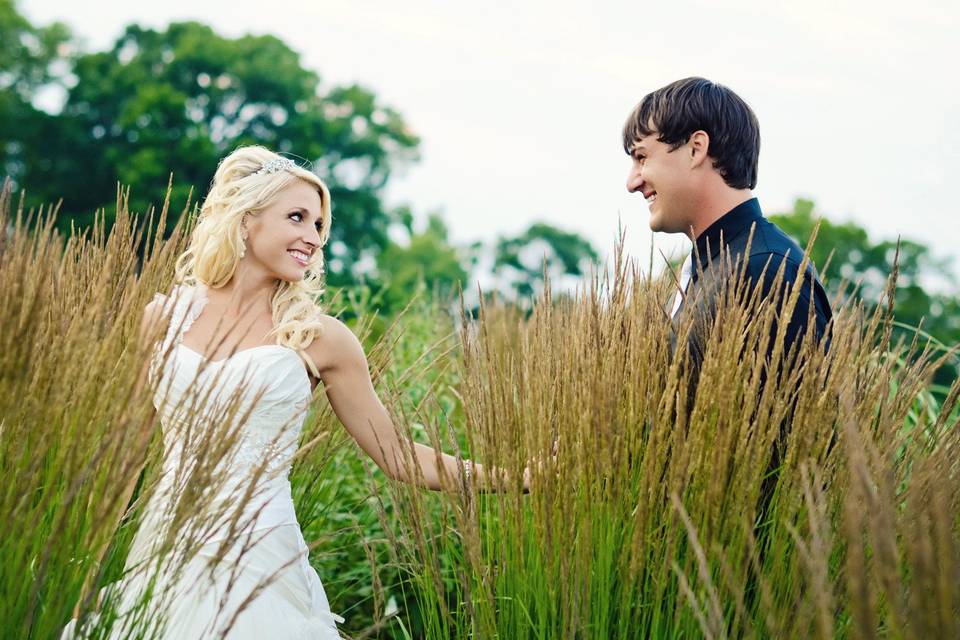 Bride and groom in tall grass