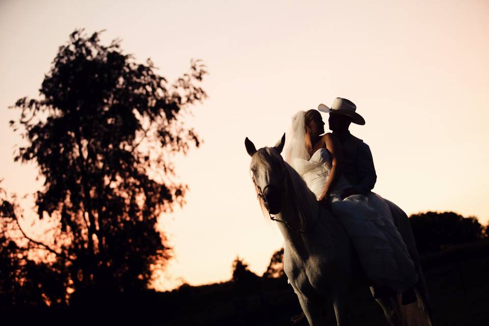 Bride and groom horseback