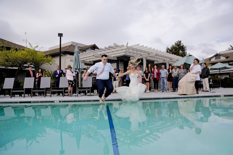 Couple jumping in pool