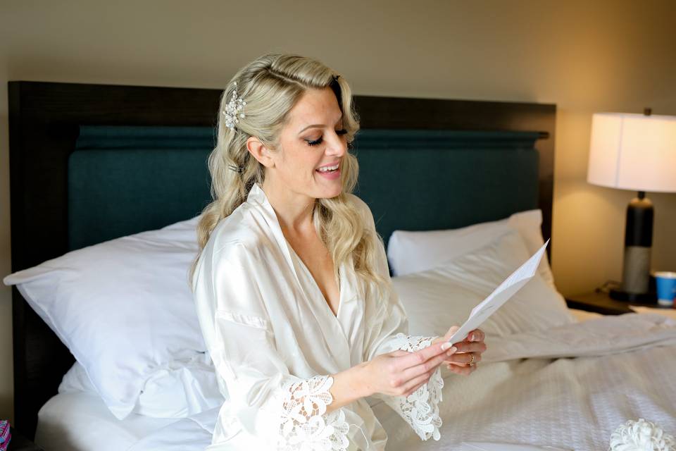 Bride reading letter in room