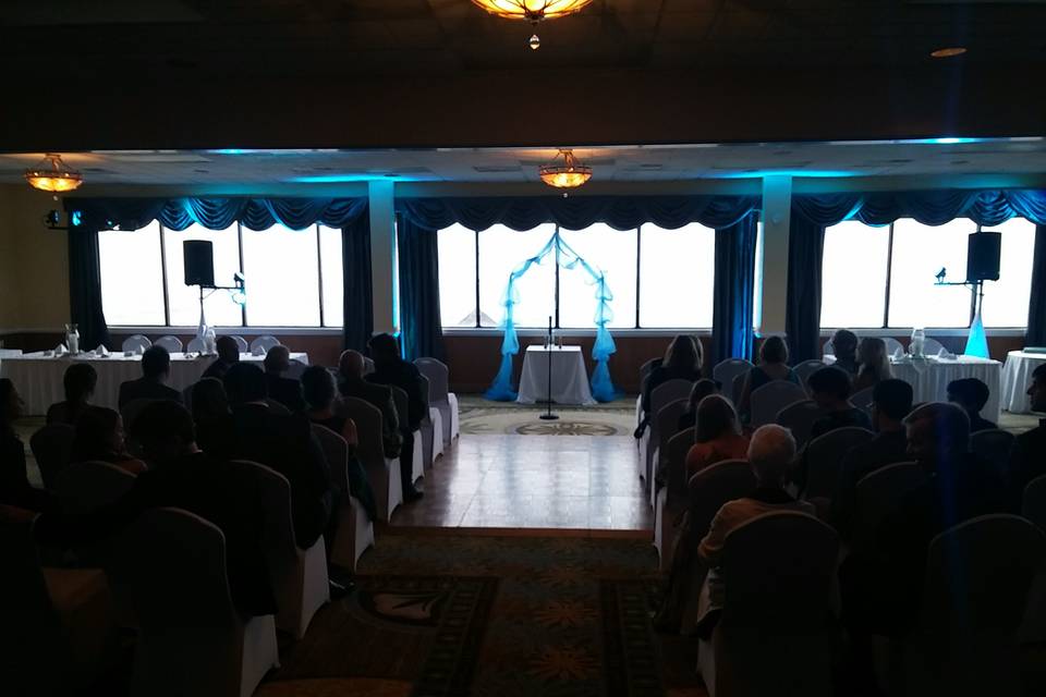 This indoor ceremony has some uplighting to enhance the general color theme of the wedding, providing a unique effect customizing a room to the clients wishes.