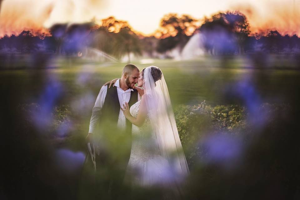 Couples photo behind flowers