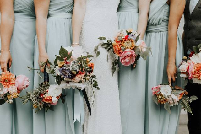 Bride and her bridesmaids holding a bouquet