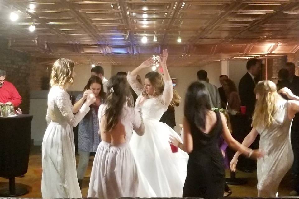 Bride and bridesmaids dancing