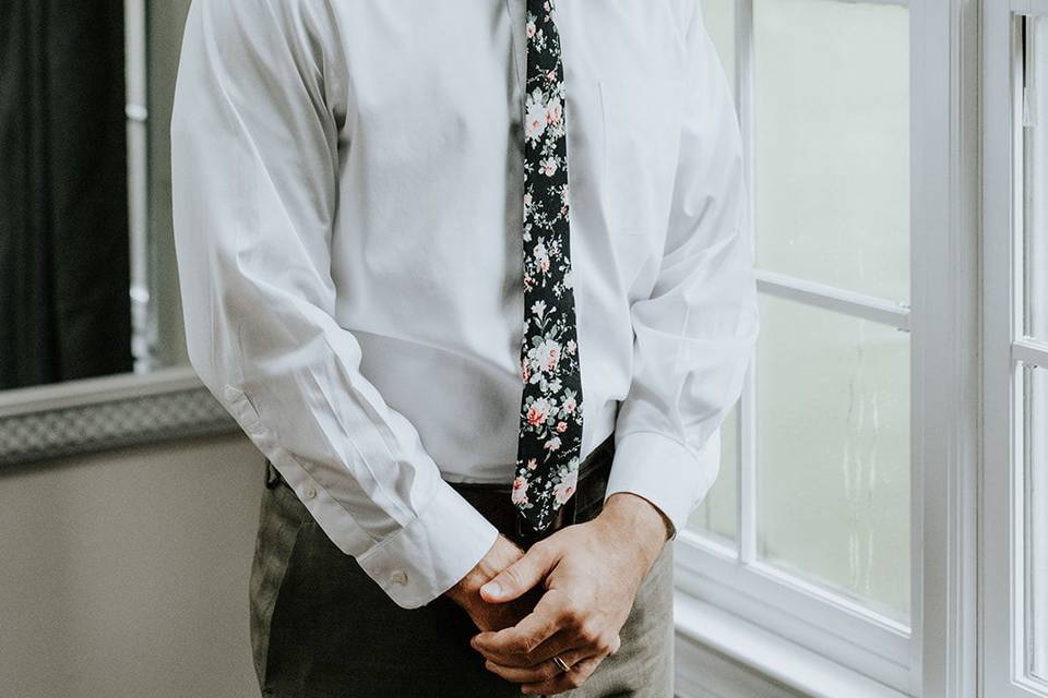 The groom taking a sneak peek at his bride