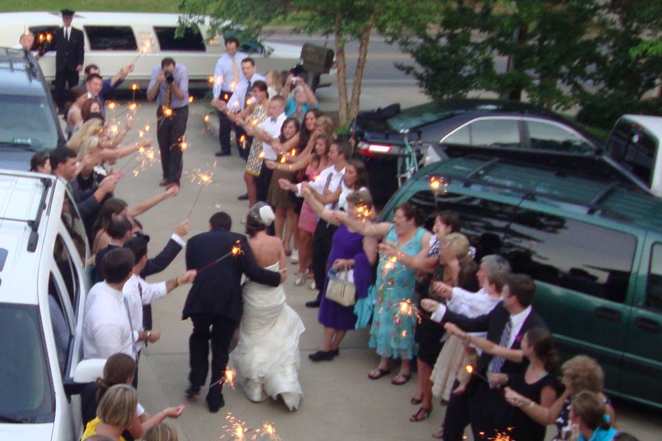 Guests celebrating the newlyweds with sparklers